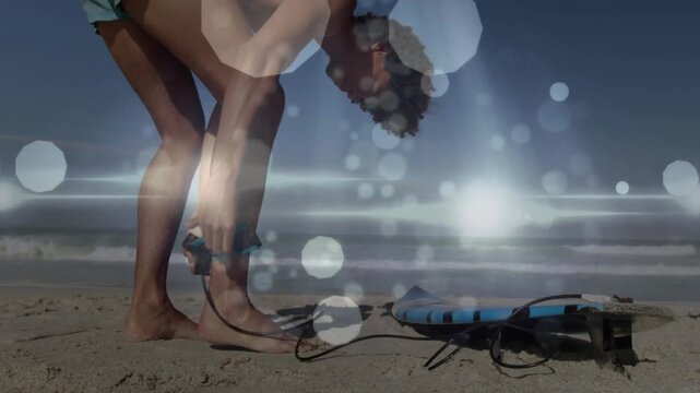 Man fastening surfboard leash on beach for sport, displaying animated wave graph and board icon