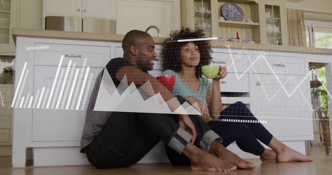 Couple sitting kitchen man leaning woman sipping, data rising over them into world map showing tech