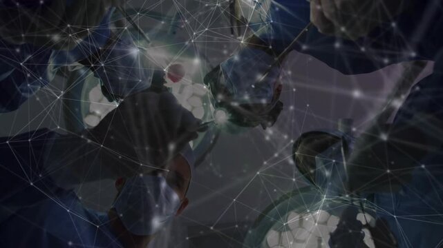 Vertical video: Leaning team in scrubs starting surgery at OR, using forceps and overlay to repair