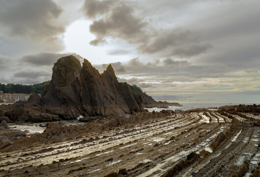 Dramatic geological flysch rock formations and cliffs at Saturraran beach in Ondarroa, Basque Country, Northern Spain
