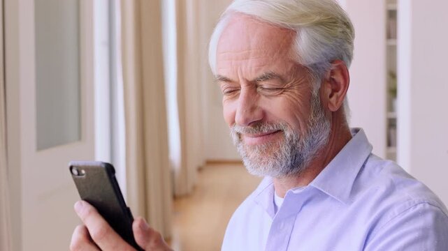 Phone, blow kiss and happy man with video call in home, communication and wave for goodbye. Virtual farewell, speaking or mature person with mobile for connection, networking or gesture for affection