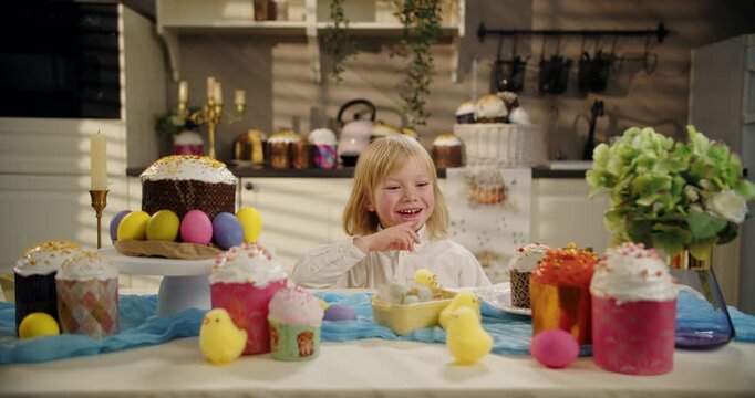 Little boy pointing at Easter cake and smiling