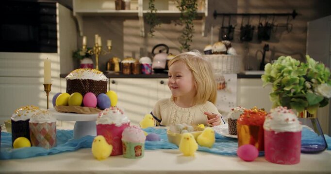 Smiling little boy with chick at Easter table