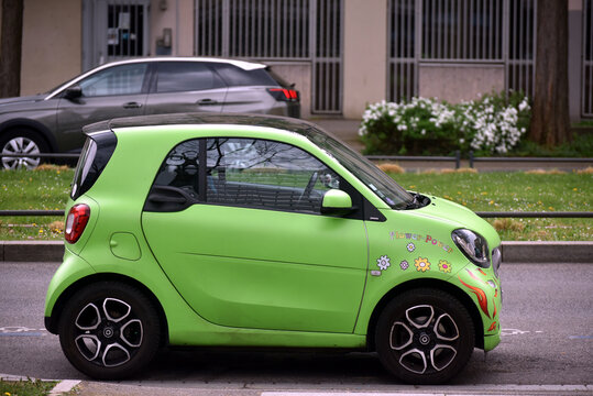 Mulhouse - France - 10 April 2026 - profile view of green smart car parked in the street