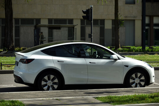 Mulhouse - France - 10 April 2026 - profile view of white tesla electric car parked in the street