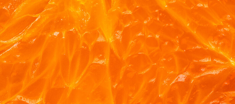 Macro shot of fresh orange pulp texture background,Extreme close-up macro photography of fresh juicy orange fruit pulp. The image highlights the vibrant orange texture, translucent juice vesicles,