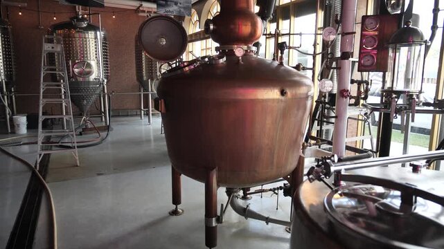 Craft whisky production process in a local distillery, Calgary, Alberta, Canada. Copper vessel.