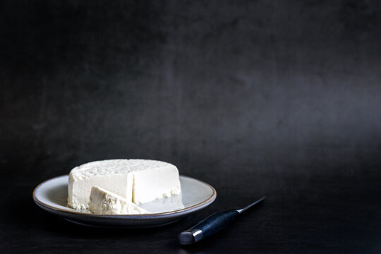 Queso blanco on a gray ceramic plate dark backdrop