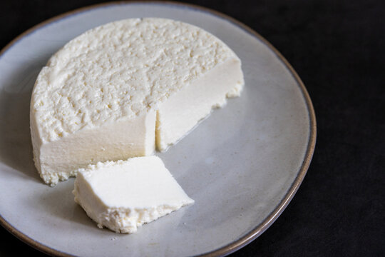 Queso blanco on a gray ceramic plate dark backdrop