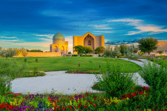 Turkestan, Kazakhstan - June 03, 2025: Scenic early morning sunrise view of the historical Mausoleum of Khoja Ahmed Yasawi (Қожа Ахмет Ясауи) surrounded by spring flowers