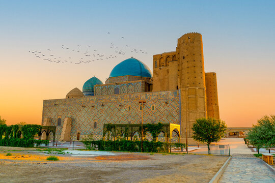 Turkestan, Kazakhstan - June 03, 2025: Scenic early morning sunrise view of the historical Mausoleum of Khoja Ahmed Yasawi (Қожа Ахмет Ясауи) showcasing the blue domes and intricate tilework walls