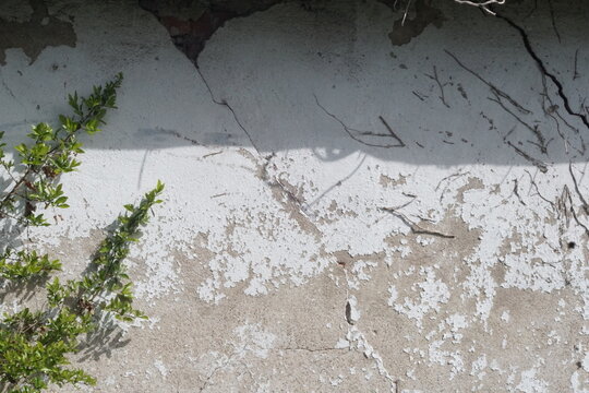 Cracks appeared on an old white wall