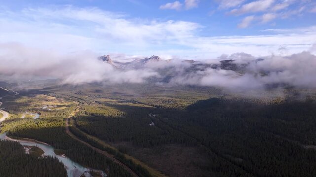 Majestic mountain peak covered in the clouds near Banff National Park, Alberta, Canada. Road trip in Canada. Rocky mountains. 4k footage