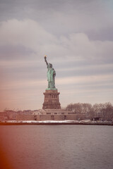 Fototapeta premium Statue of Liberty on a Cloudy Winter Day, New York Harbor, USA