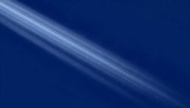 Abstract diagonal light streaks with tiny particles against a deep blue background