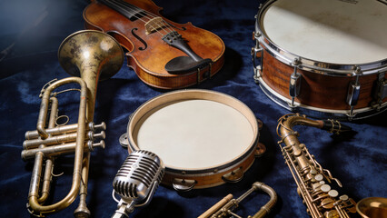 Fototapeta premium Vintage Style Grouping of Various Detailed Musical Instruments on Blue Cloth