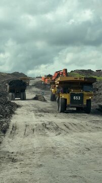 Heavy Duty Dump Truck Transporting Coal in Open Pit Mining Site