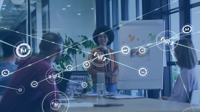 Animation of icons connected with lines over diverse female explaining graphs to coworkers in office