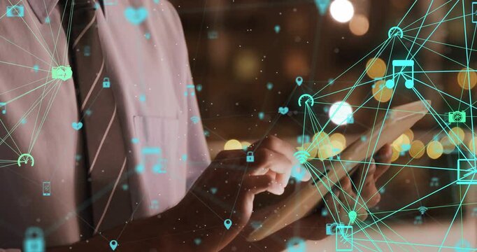 Business pro tapping tablet by window generating teal icons shifting right onto tablet for business