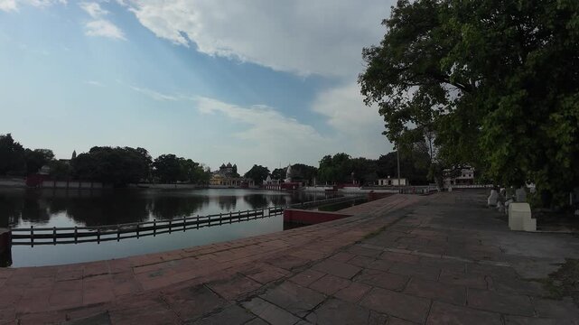 a Sacred Holy Pond with Stone Steps and Traditional Architecture under a Cloudy Sky, Kurukshetra, India 