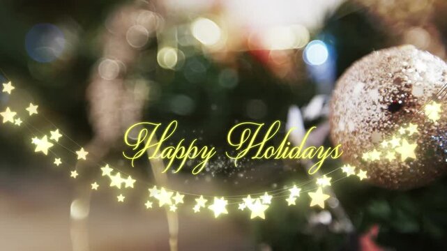 Animation of text, happy holidays, in yellow, over string lights and blurred christmas decorations