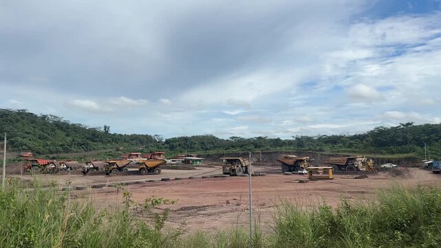 Wide Shot of Heavy Duty Mining Dump Trucks Parked at Open Pit Mine Site