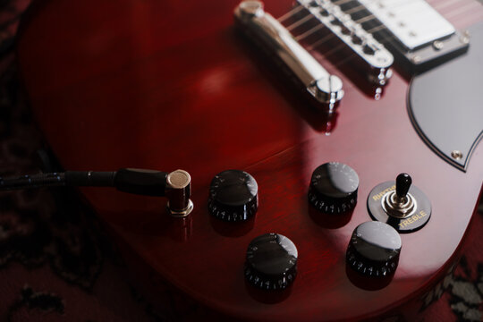 Electric red sg guitar on carpet. Music rock background
