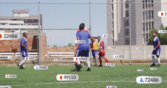 Animation of media icons over diverse male soccer players playing match