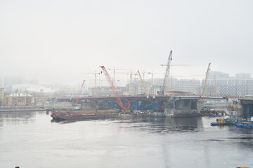 Fototapeta premium Quiet shipyard enveloped in fog and reflected water lights