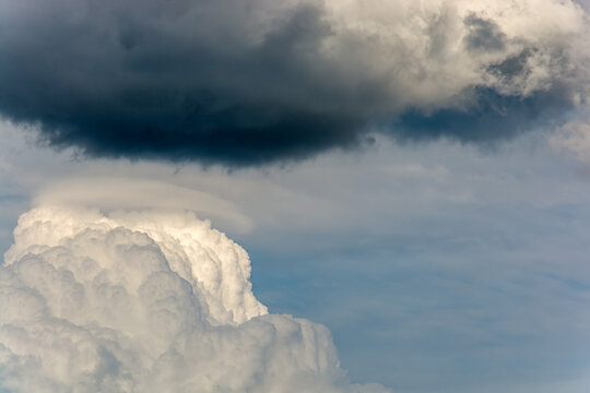 Powerful Cumulus congestus cloud with a pileus cap in a dramatic sky.