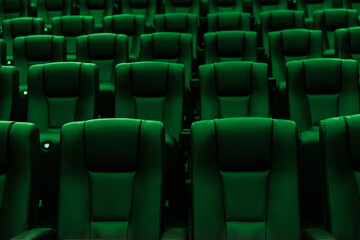Fototapeta premium Rows of empty green cinema seats in modern movie theater
