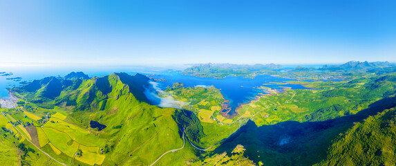 Aerial drone view of fjords and mountains in Lofoten islands, Norway. Panoramic view. Scenic arctic landscape with high peaks, blue ocean and northern nature. © biletskiyevgeniy