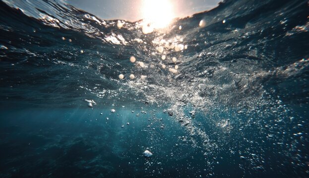 Underwater Sunlight Rays Breaking Through Rippling Water Surface.