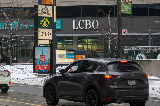Toronto street scene featuring business signs and traffic