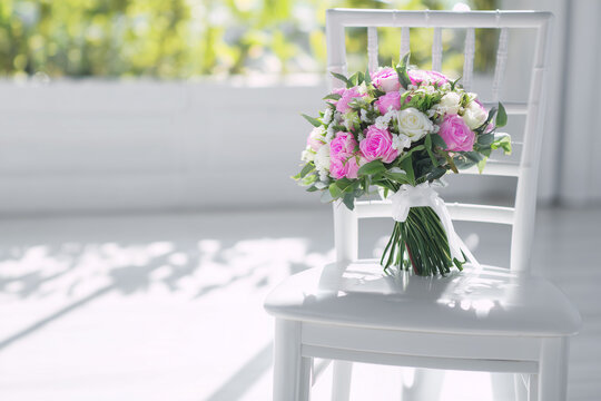 Flower bouquet background on white chair, copy space