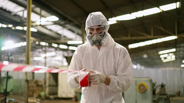 Protective suit respirator factory worker safety hazard biohazard contamination hazmat industrial response and inspection scene with caution tape, protective glove, container handling, warehouse