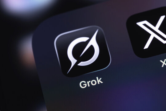Grok and X mobile icon app closeup on a screen smartphone iPhone. Grok is a modern AI-powered chatbot developed by xAI. Batumi, Georgia - March 19, 2026