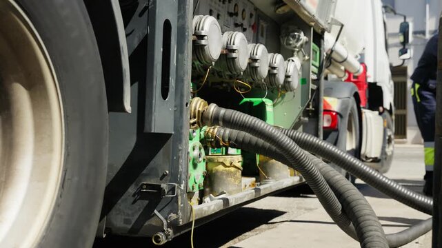 Fuel tanker truck refuels gas station tank during petrol shortage crisis