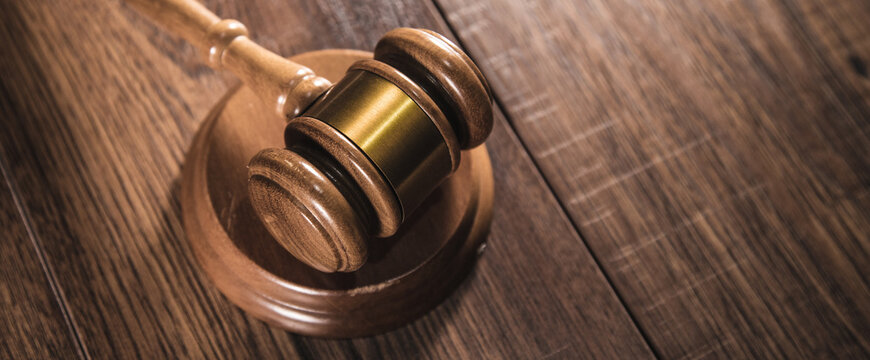 Judge gavel on grey table.