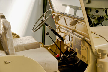 Fototapeta premium View of the interior of a vintage military vehicle showing the steering wheel and gear levers from the driver’s seat with minimal details