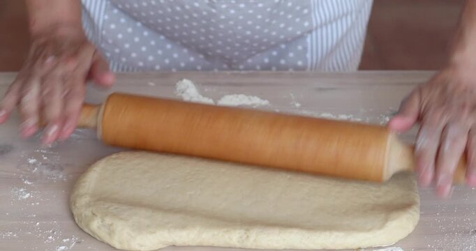 Rolling Sweet Dough with Wooden Rolling Pin for Homemade Dessert Preparation, Close Up, Unrecognizable People