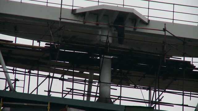 man welding on construction in ship yard