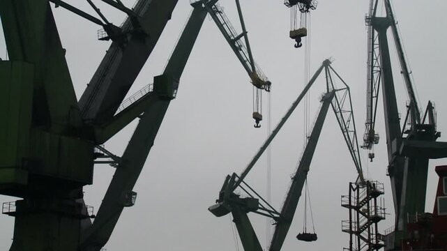 cranes on ship yard against sky