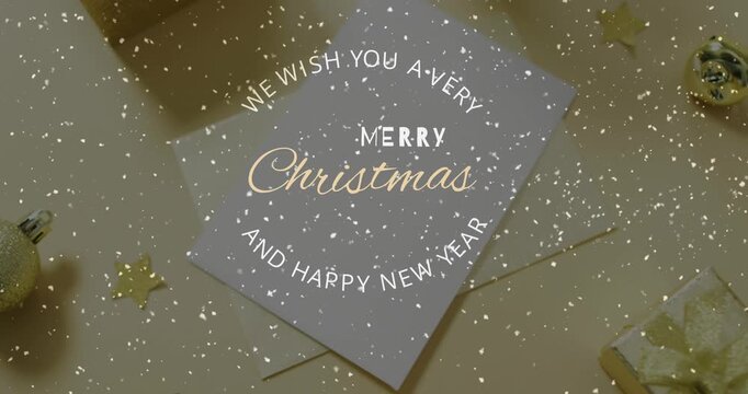 Animation of christmas greetings text over snow falling and decorations