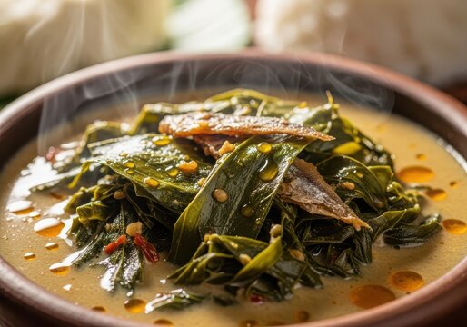 Traditional indonesian dish of cassava leaves in coconut milk with fish
