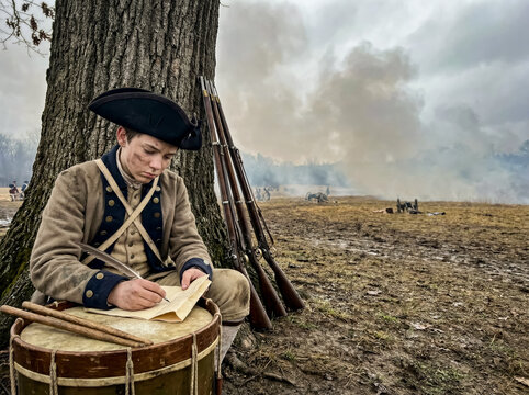 Postcard template young continental soldier writing letter on drum base during revolutionary war battle.