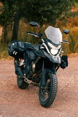 Fototapeta premium Adventure touring motorcycle parked on gravel road, exploring travel concept