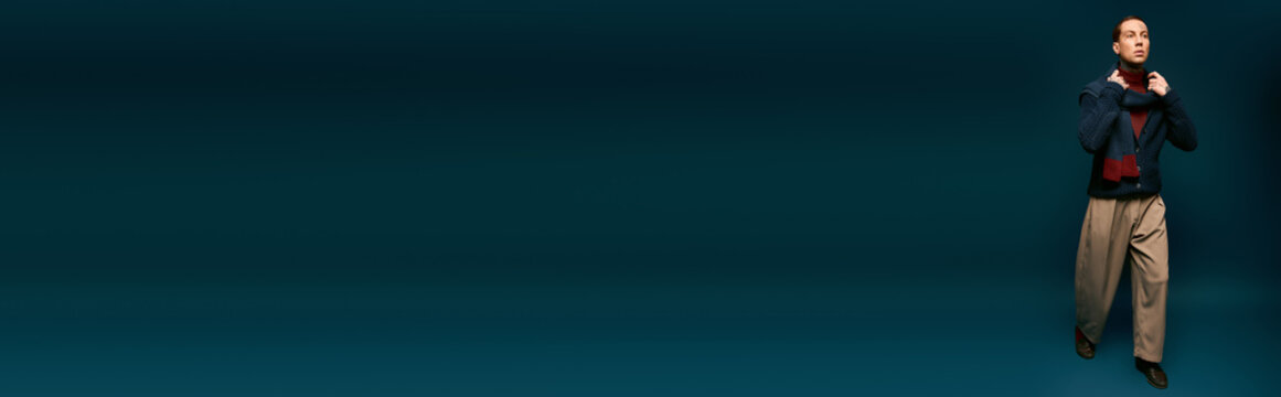 Handsome young man showcasing effortless style in a striking fashion setting