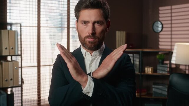 Confident Caucasian middle-aged business man crossing arms border no negative gesture reject deny sign adult businessman male executive agent showing forbidden stop gesture crossed hands in office