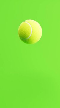 Tennis Ball Bouncing on Green Background with Copy Space, Vertical Portrait Format, Seamless Loop 3D Animation